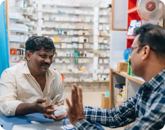 Medical store owner helping patient with online doctor consultation